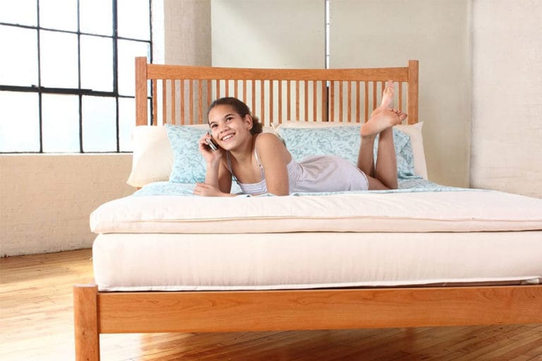 A Girl Relaxing on a Platform Bed Mattress