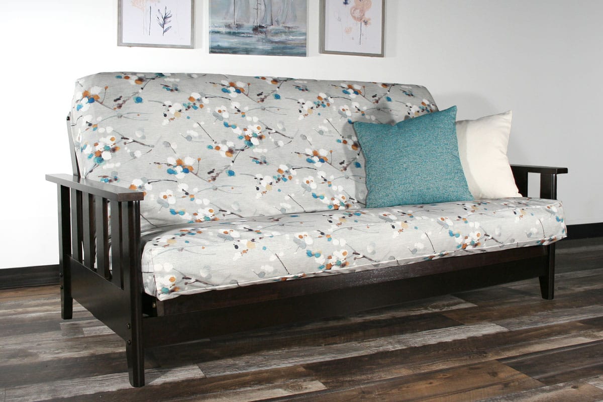 A Futon Frame with Mattress and Accent Pillows